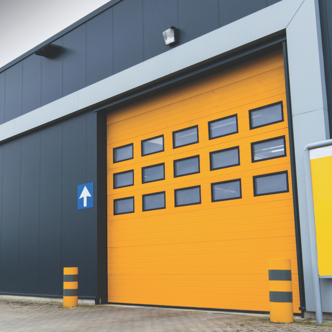 Large yellow door on the exterior of a factory.