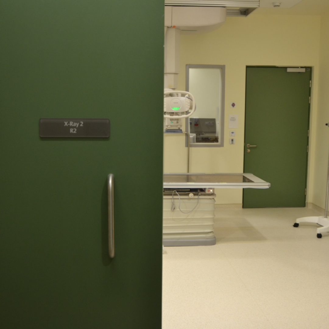 A green x-ray door half open.