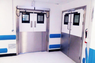 A small room in a hospital with double doors.