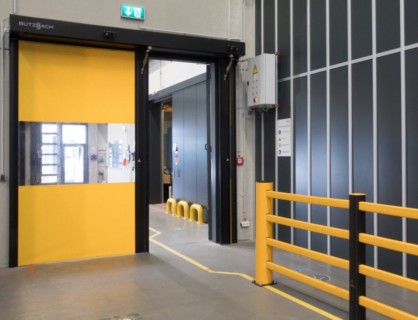 Yellow Novosprint high speed door in a warehouse.