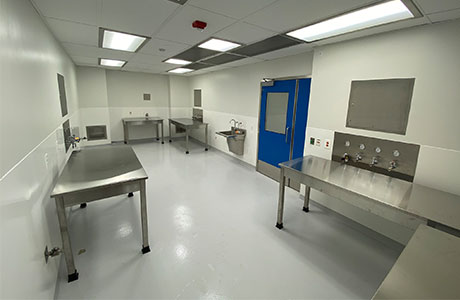 A room with stainless steel tables and a blue door.