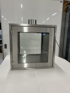 A metal transfer hatch with a small window at each side.