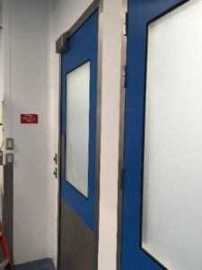 A blue cleanroom swing door. 