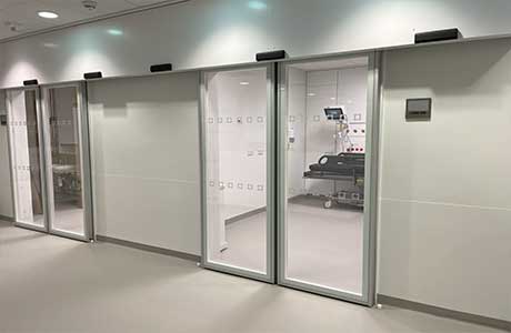 Two sets of hermetic glass operating theatre doors.